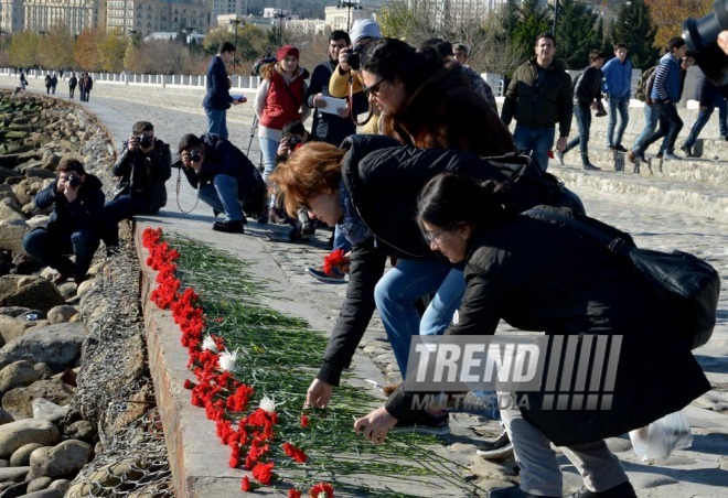 Baku residents bringing flowers to Seaside Boulevard to honor missing oil workers.  Azerbaijan, Dec.07, 2015